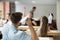 Caucasian male worker launching paper plane in office