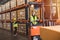 Caucasian male worker working in warehouse goods store. inventory staff moving producs pallet shipping management with folk lift