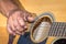 A Caucasian males hands playing an acoustic guitar