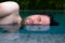Caucasian man is afraid to swim in swimming pool. He do not like chlorine water and closes his eyes