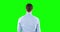 Caucasian man back to camera on green background