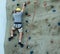 Caucasian Man Bouldering with Safety Harness and Helmet