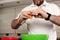 Caucasian man breaking an egg to add to a bowl, to prepare a cake