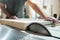 Caucasian man carpenter cutting wood with circular saw creating new furniture