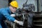 Caucasian man engineering workers wear yellow hard hat working machine lathe metal in factory industrial. mechanical operator male