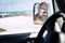 Caucasian man face with sunglasses viewed in the mirror of the car - alternative people portrait - travel vehicle concept