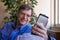 Caucasian man in forties smiling, looking at cellphone