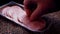 Caucasian man hand takes circle of thinly sliced ham from plastic package