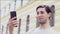 Caucasian man holds a phone on his hand and communicates by video call. Blogger guy sincerely smiles on phone camera on th