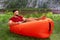Caucasian man on inflatable lounger near river