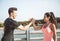 Caucasian man and Latin woman greet each other before they start doing sports on the side of a lake in a park in the city of