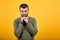 Caucasian man looking at camera, keeping hand on chin having nice clock