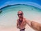 Caucasian man makes selfie at the Flores Taka Makassar Beach