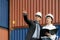 A caucasian man manager explaining logistics transportation system in the container depot terminal to the female secretary