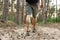 Caucasian man muscular legs trekking along ground path