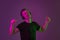Caucasian man`s portrait isolated on purple studio background in neon light
