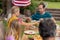 Caucasian man serving family before eating meal together in garden