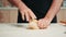 Caucasian man shaping a bread loaf