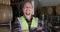 Caucasian man smiling at camera and wearing high visibility vest