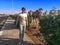 Caucasian man smiling posing against the backdrop of a one-humped camel on the street of Sharm El Sheikh Egypt. Adult guy near