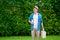 Caucasian man standing and hokding book and luggage