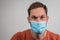 Caucasian man is wearing or presenting a flu or covid face mask or protective mask over his mouth. Coronavirus prevention man,