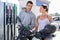 Caucasian man and woman refuelling motorbike in gas station