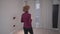 Caucasian mature woman inspecting an empty apartment before signing a lease agreement. An elderly woman looks at an