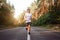 Caucasian middle age man athlete runs sunny summer day on asphalt road in the forest