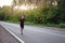 Caucasian middle age man athlete runs sunny summer day on asphalt road in the forest