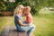 Caucasian mother and boy toddler son sitting together face to face and talking to each other