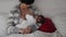 Caucasian mother breastfeeding her newborn baby on the bed