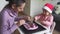 Caucasian mother with daughter cooking christmas cookies together. Holiday traditional home activities with kids