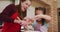 Caucasian mother and daughter wearing aprons baking together in the kitchen at home