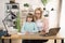 Caucasian mother helps with task little schoolgirl daughter do together schoolwork