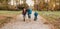 Caucasian mother is teaching her kids to ride the bike during a walking in the park