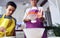 Caucasian mother teaching her son how to cook preparing the ingredients to make a cake. Child pouring flour to sift