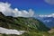 Caucasian mountain range against the background of blue sky and clouds