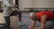 Caucasian muscular man exercising, doing plank with female coach