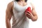 Caucasian muscular man holding fake red heart in front of his chest heart treatment concept no face visible white