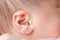 Caucasian Newborn baby ear closeup macro detail shot. child portrait, health skin, tenderness, maternity and babyhood