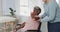 Caucasian nurse with senior woman in wheelchair exercising with copy space, slow motion