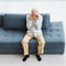 Caucasian old senior elderly stressed depressed worried upset gray hair and bearded man sitting on sofa in living room at home