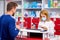 Caucasian pharmacist is working with customer in modern drugstore