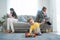 Caucasian phone addict parents don`t pay attention with baby toddler. Family problem, Father and Mother sit on sofa and using