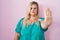 Caucasian plus size woman standing over pink background doing stop sing with palm of the hand