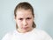 Caucasian pre-teen girl with frowning eyebrows and heavy look, angry young child, grey background, series