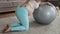 Caucasian pregnant woman suffers from back pain. Fitball training during pregnancy.