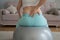 Caucasian pregnant woman suffers from back pain. Fitball training during pregnancy.