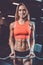 Caucasian pretty fitness girl on diet training pumping up muscle